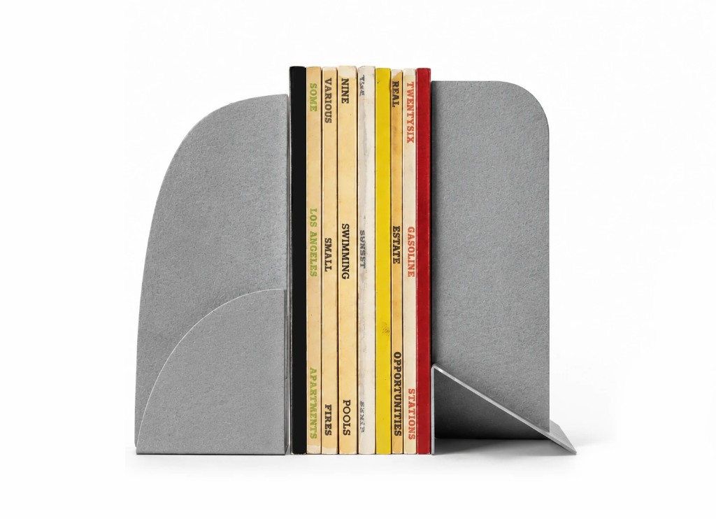 PCSB steel bookends holding a row of books — Philip Cronerud